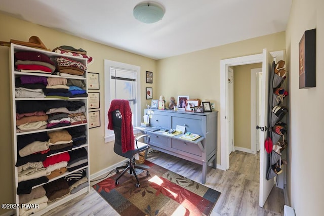 bedroom with wood finished floors and baseboards