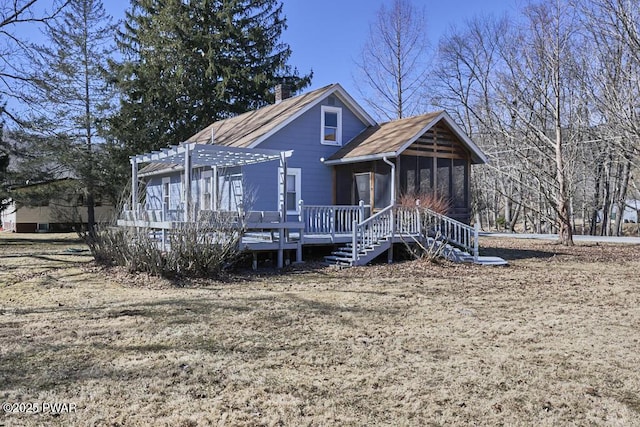 view of front of house featuring a sunroom, a deck, a chimney, and a pergola