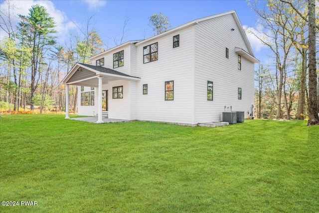 back of house with a yard and central AC unit