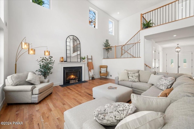 living room featuring wood-type flooring and a high ceiling