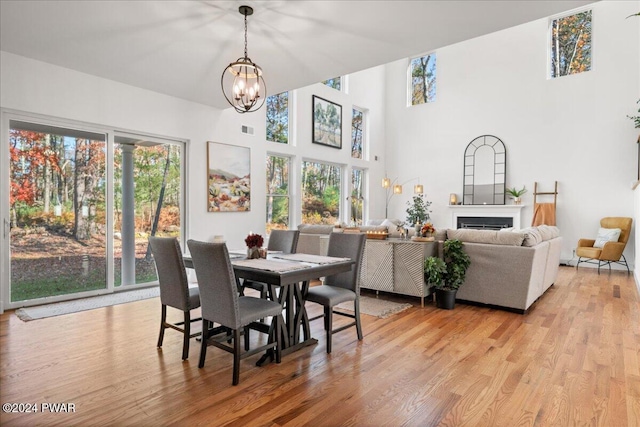 dining room featuring plenty of natural light, light wood-type flooring, and a chandelier