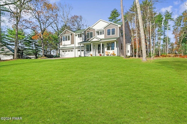 view of front of house featuring a front lawn and a garage