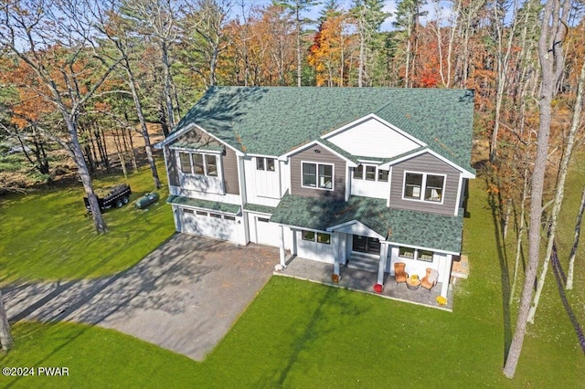 view of front of home with a front yard and a garage