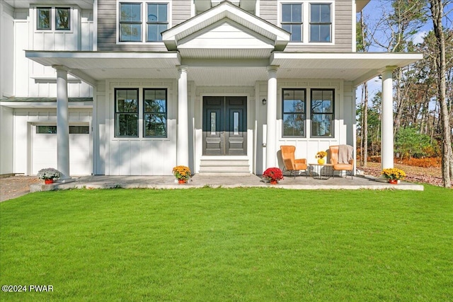 property entrance with a porch and a yard