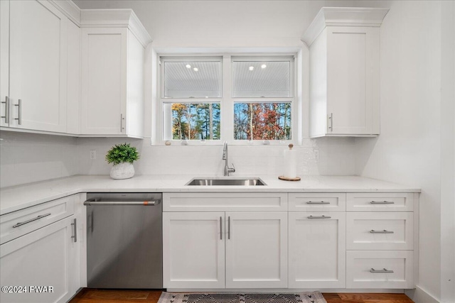 kitchen featuring dishwasher, white cabinets, and sink