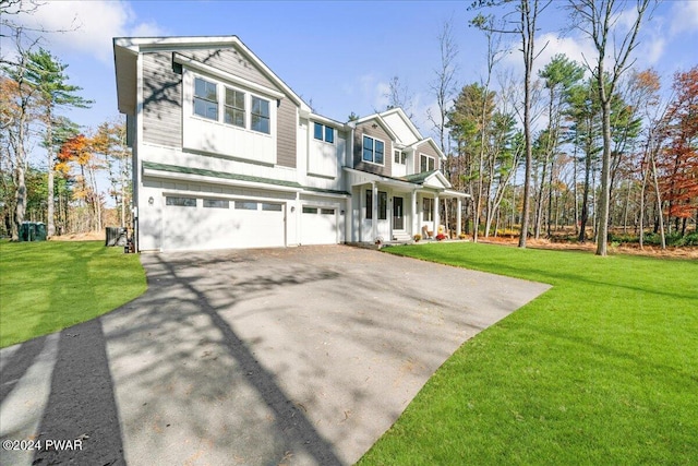 view of front of home featuring a front yard and a garage