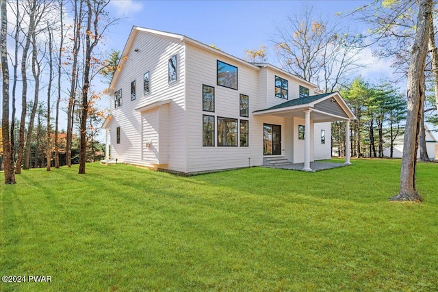 rear view of property featuring a yard