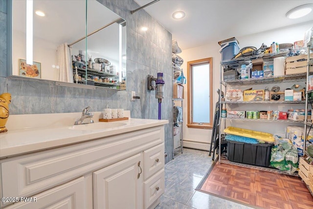 bathroom with vanity, a shower with curtain, decorative backsplash, parquet flooring, and tile walls