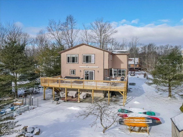 snow covered property featuring a deck