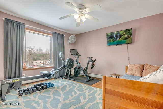 workout area featuring hardwood / wood-style floors and ceiling fan