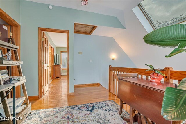 interior space featuring light hardwood / wood-style flooring and lofted ceiling