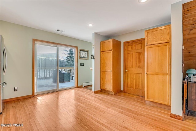 interior space with light hardwood / wood-style flooring and baseboard heating