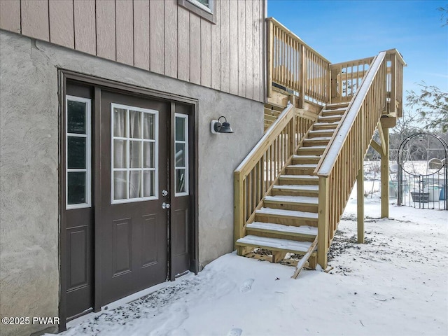 view of snow covered property entrance