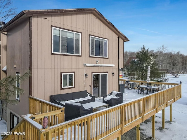 snow covered property featuring a deck