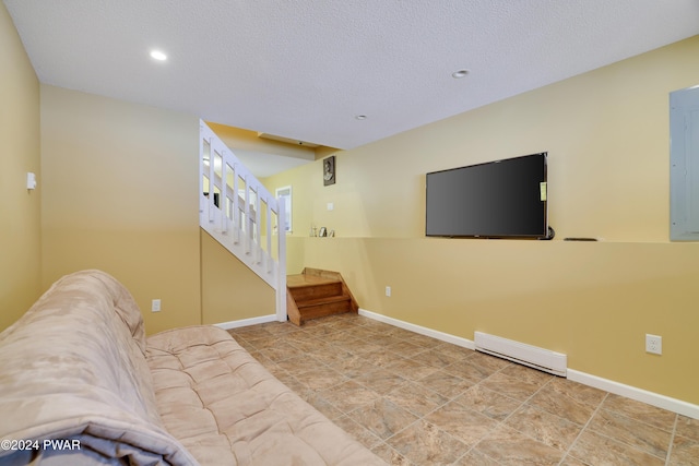 living room with a textured ceiling and baseboard heating