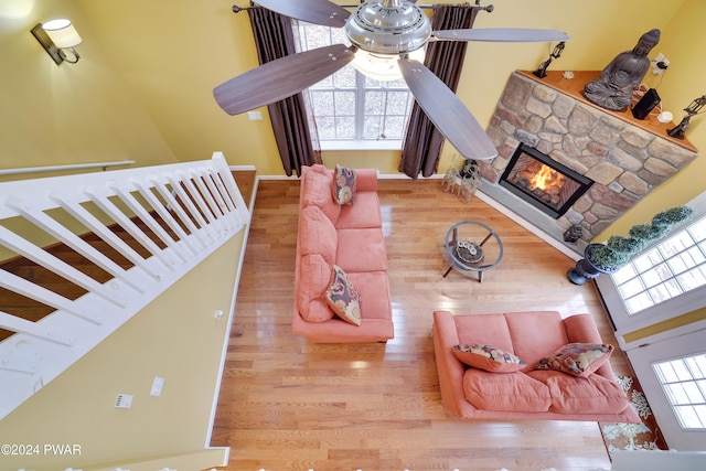 living room with a fireplace, hardwood / wood-style floors, and ceiling fan