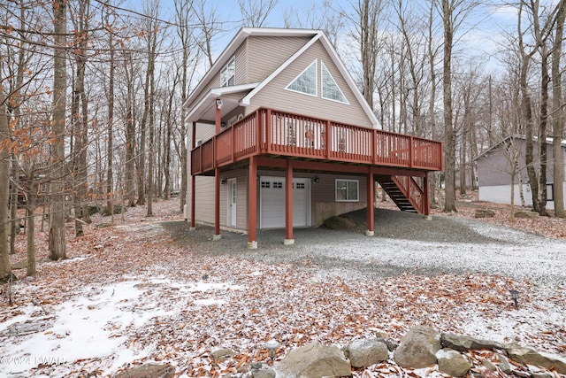 exterior space featuring a garage and a wooden deck