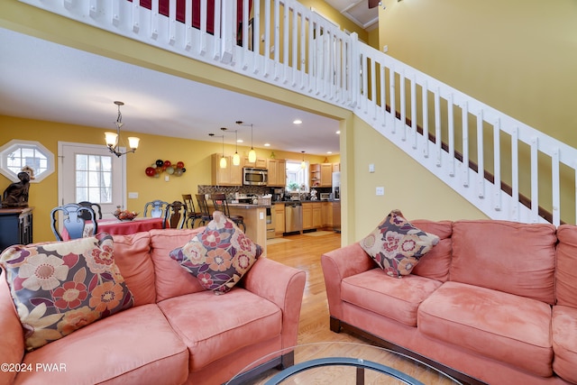 living room with a notable chandelier and light wood-type flooring