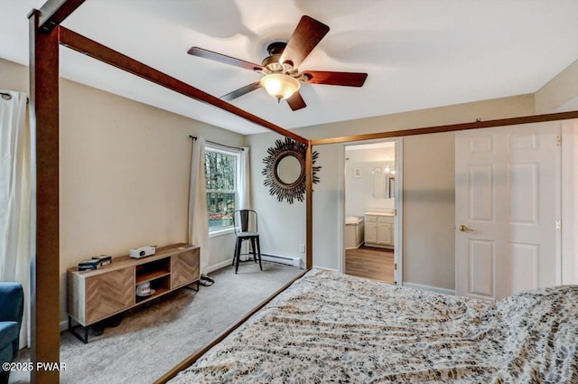 bedroom with baseboards, ensuite bath, a baseboard radiator, ceiling fan, and carpet floors