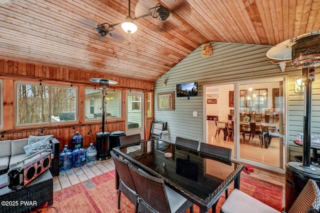 sunroom featuring vaulted ceiling and wooden ceiling