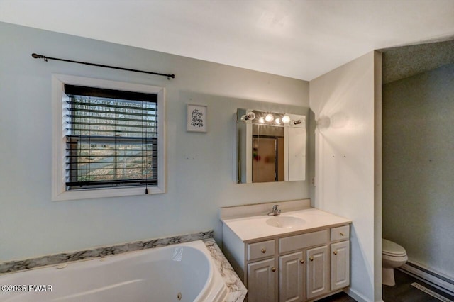 full bath with a baseboard radiator, toilet, vanity, and a whirlpool tub