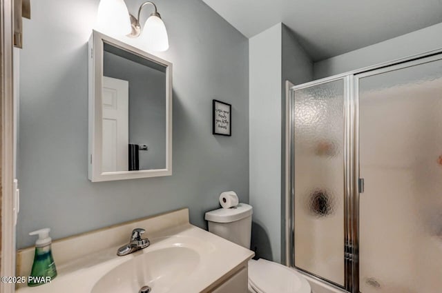 full bath with toilet, a shower stall, and vanity