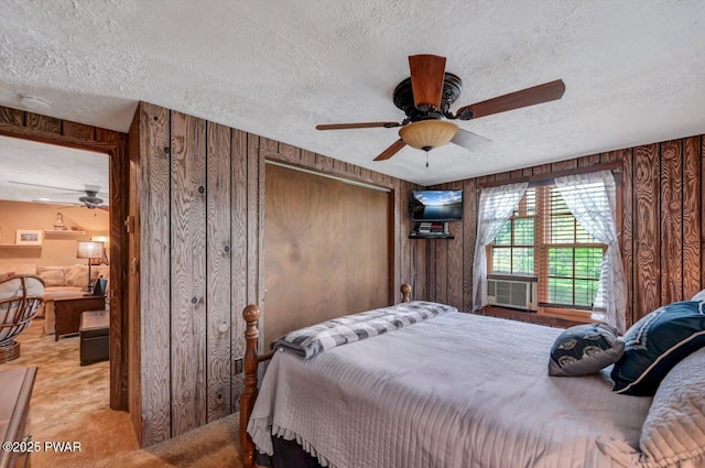 29 Tanglewood Ln, Lake Ariel, PA 18436 - bedroom with a textured ceiling, cooling unit, carpet, a closet, and wood walls