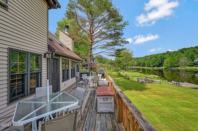 29 Tanglewood Ln, Lake Ariel, PA 18436 - wooden terrace with outdoor dining space, a lawn, and a water view
