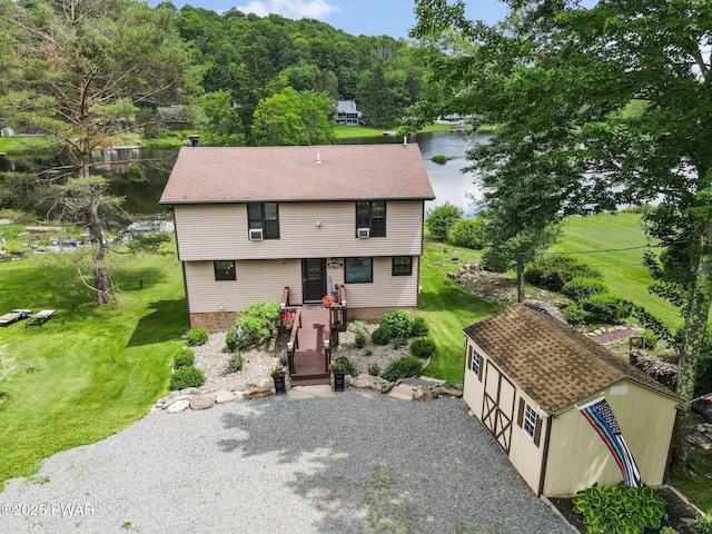 29 Tanglewood Ln, Lake Ariel, PA 18436 - view of front facade with an outdoor structure, a front yard, driveway, a garage, and a water view