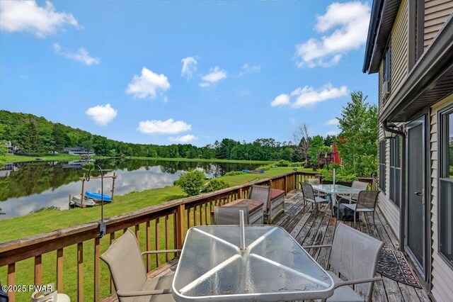 29 Tanglewood Ln, Lake Ariel, PA 18436 - wooden deck with outdoor dining area, a water view, and a yard