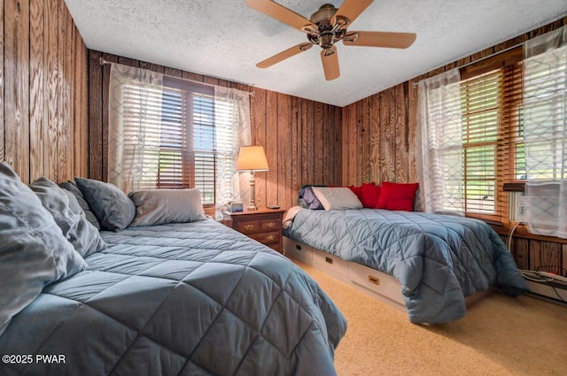 29 Tanglewood Ln, Lake Ariel, PA 18436 - bedroom featuring carpet, wooden walls, a textured ceiling, multiple windows, and ceiling fan