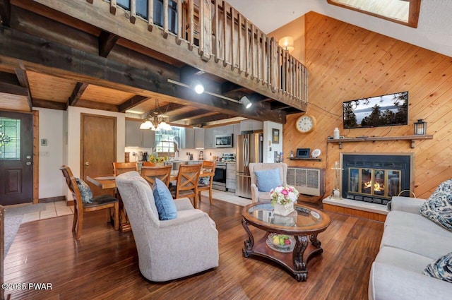 29 Tanglewood Ln, Lake Ariel, PA 18436 - living room featuring hardwood / wood-style flooring, wooden walls, a glass covered fireplace, a chandelier, and beam ceiling