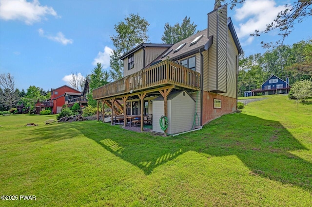 29 Tanglewood Ln, Lake Ariel, PA 18436 - rear view of house featuring a wooden deck, a yard, and a chimney