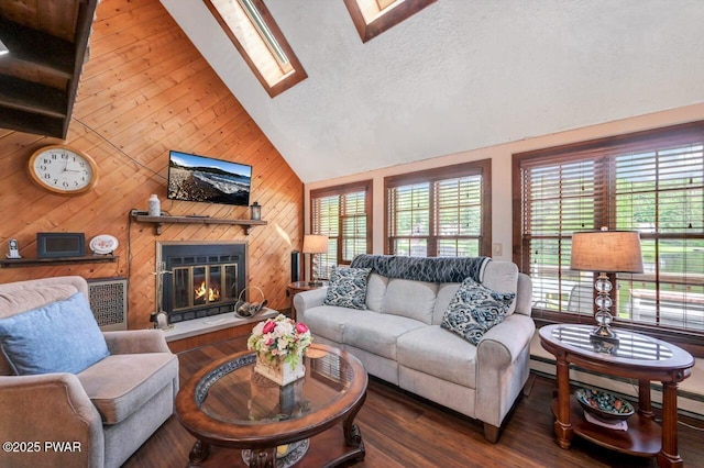 29 Tanglewood Ln, Lake Ariel, PA 18436 - living area with a skylight, lofted ceiling, wood finished floors, wooden walls, and a glass covered fireplace