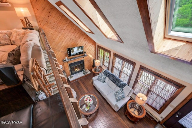 29 Tanglewood Ln, Lake Ariel, PA 18436 - living area with wooden walls, hardwood / wood-style flooring, a skylight, and a glass covered fireplace
