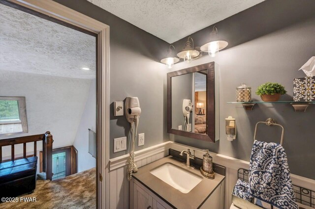 29 Tanglewood Ln, Lake Ariel, PA 18436 - bathroom with a textured ceiling, vanity, and lofted ceiling