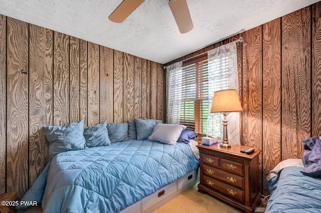29 Tanglewood Ln, Lake Ariel, PA 18436 - carpeted bedroom featuring a textured ceiling, wood walls, and a ceiling fan