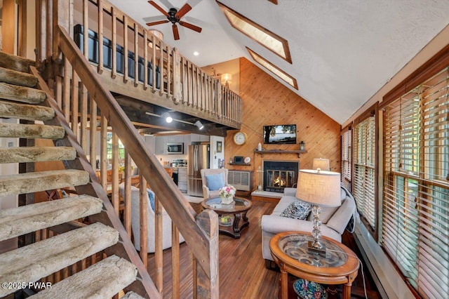 29 Tanglewood Ln, Lake Ariel, PA 18436 - living area featuring wooden walls, wood finished floors, a ceiling fan, stairs, and a skylight