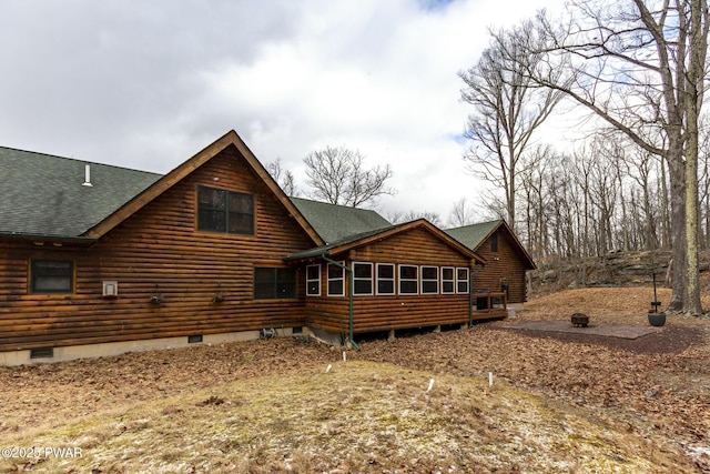 back of property with a sunroom