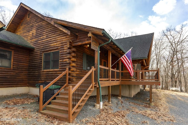 rear view of property featuring a wooden deck