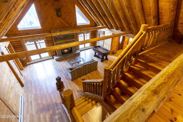 living room with beamed ceiling, hardwood / wood-style flooring, high vaulted ceiling, and wooden ceiling