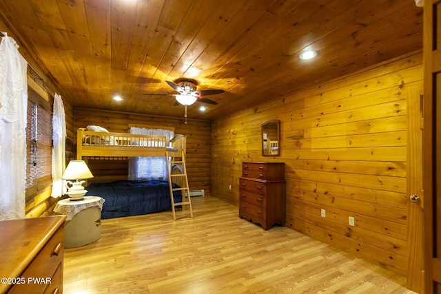 bedroom featuring wood walls, light wood-type flooring, a baseboard radiator, and wooden ceiling