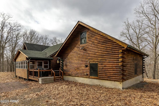 view of side of home with a sunroom