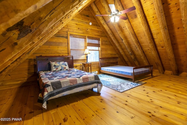 bedroom with vaulted ceiling with beams, light hardwood / wood-style flooring, ceiling fan, and wooden ceiling