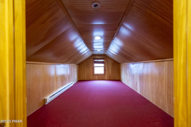 bonus room with carpet, wood ceiling, vaulted ceiling, a baseboard heating unit, and wood walls