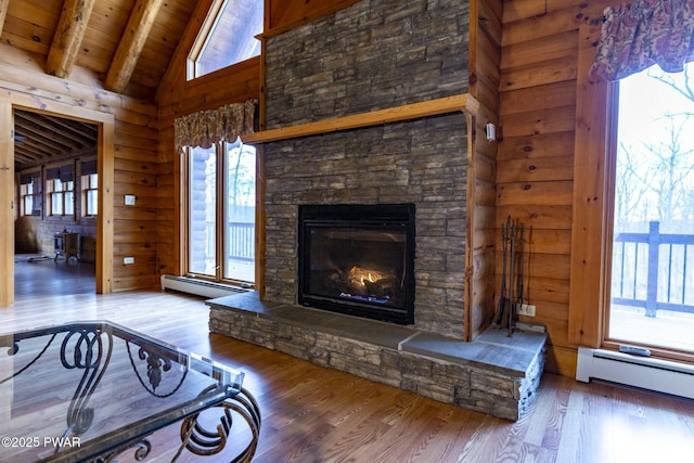 living room with beam ceiling, wooden ceiling, a baseboard heating unit, a fireplace, and hardwood / wood-style flooring