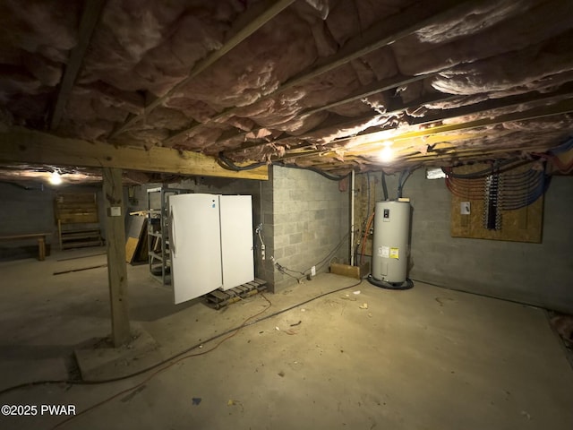 basement with electric water heater and white refrigerator