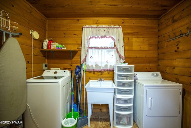 laundry area featuring wood ceiling, wood walls, and washing machine and clothes dryer