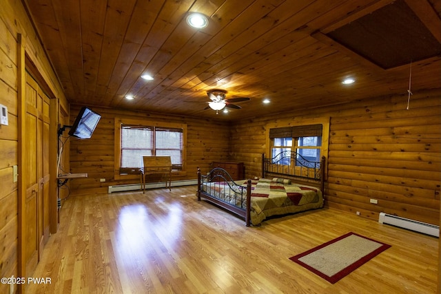 unfurnished bedroom featuring light hardwood / wood-style flooring, log walls, and a baseboard heating unit