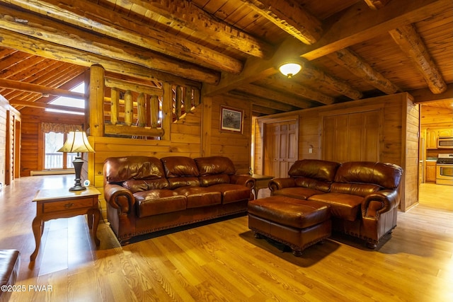 living room with beamed ceiling, wood ceiling, and wooden walls